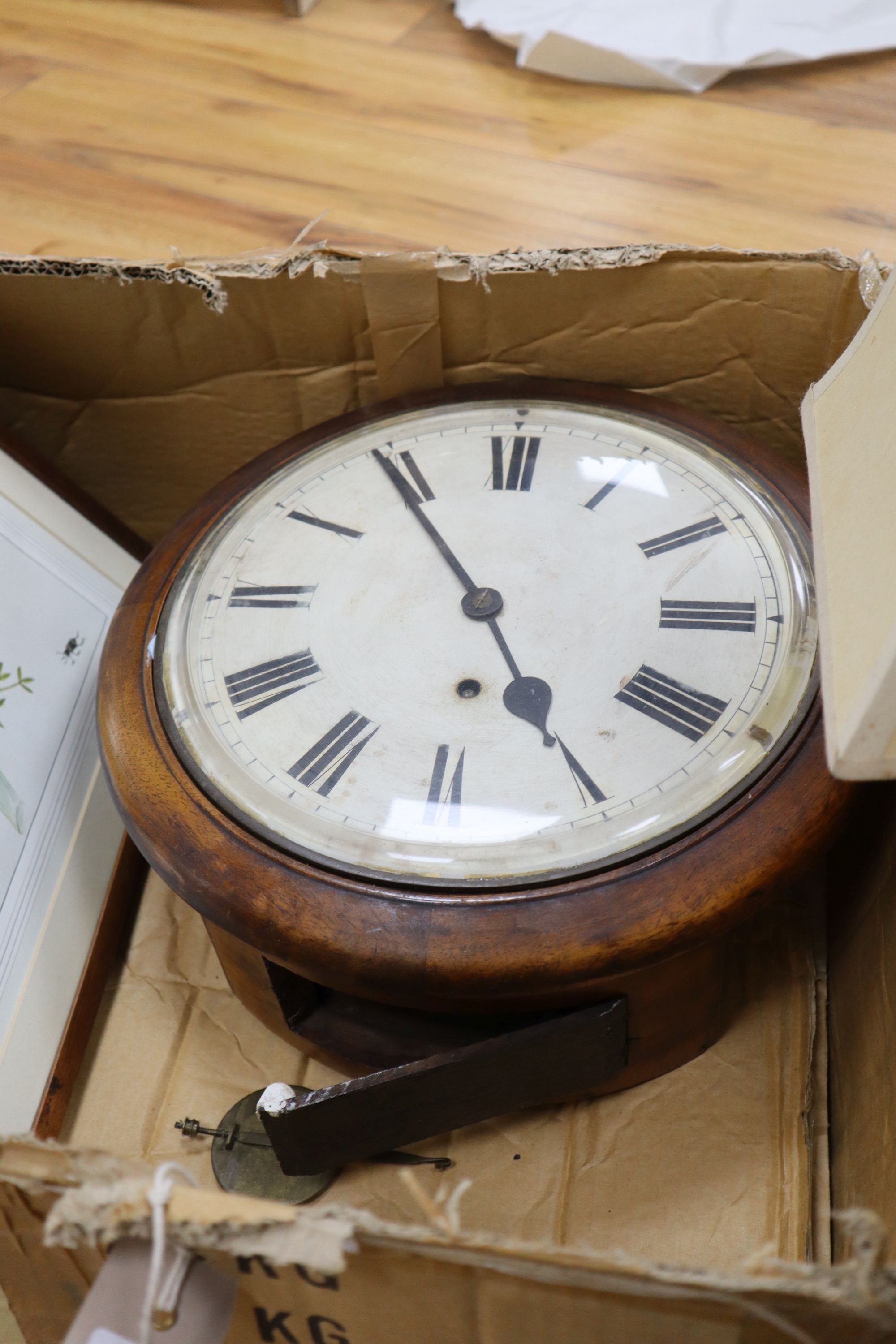 A dial clock, a carved wood table lamp and four prints